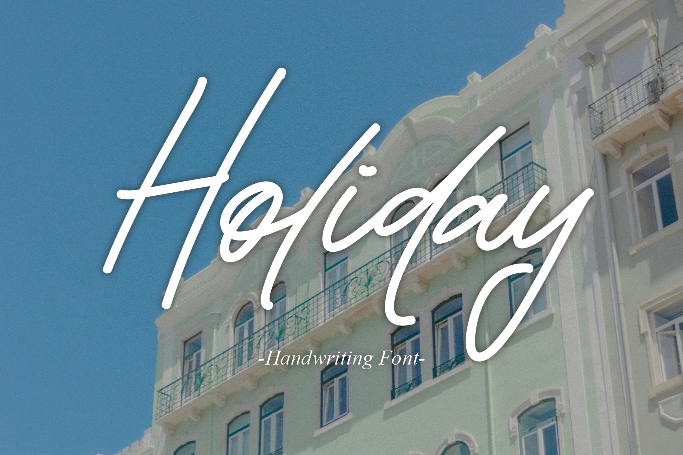 Holiday Font preview with white refined handwritten script, tall ascenders, and sweeping descenders