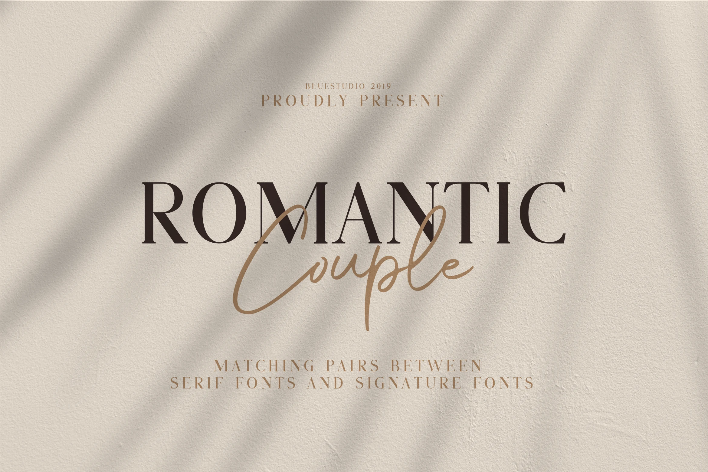 Romantic Couple Font preview with bold serif capitals and flowing signature script