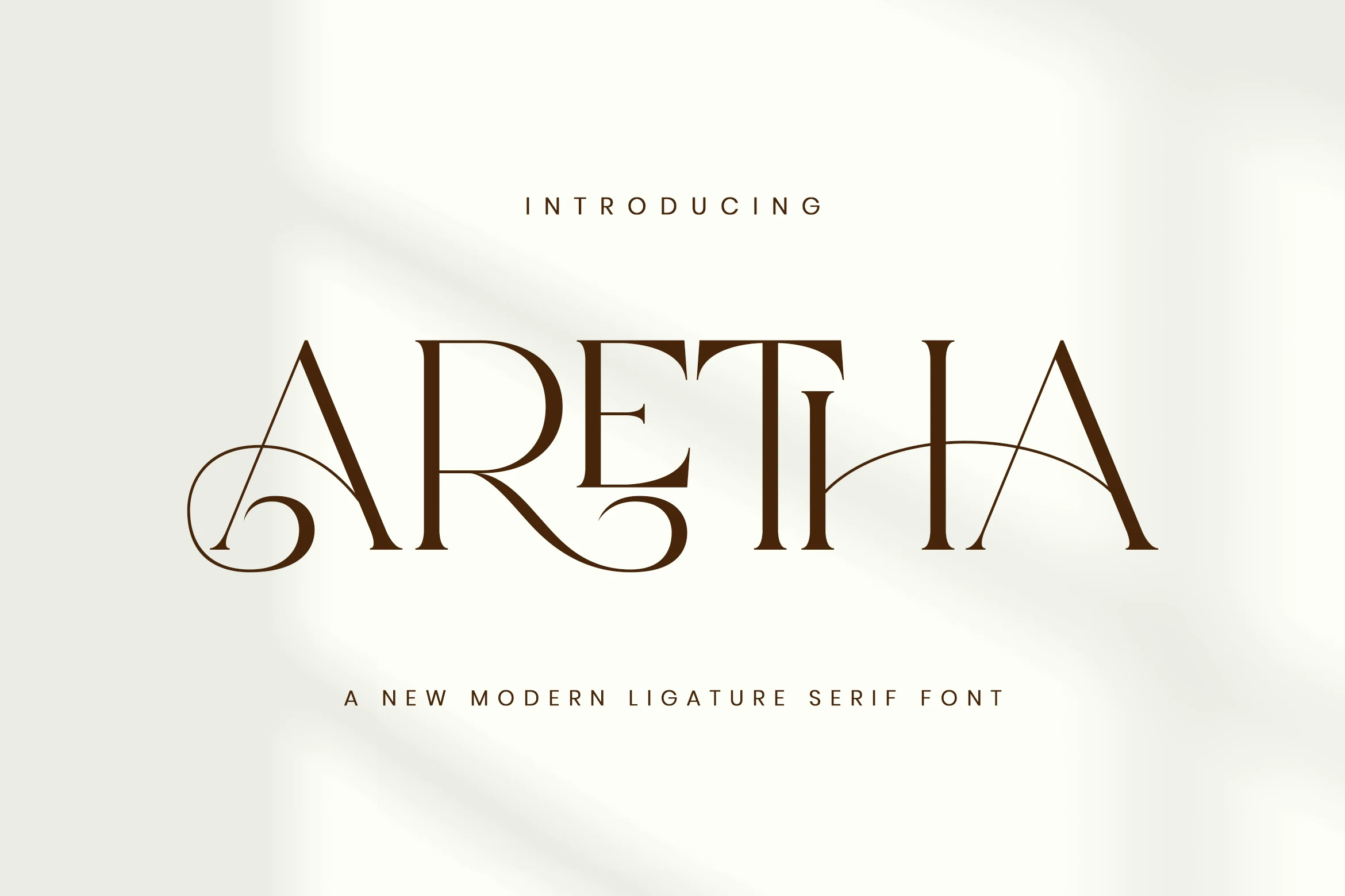 Aretha Font preview with elegant brown ligature serif lettering and sweeping swashes