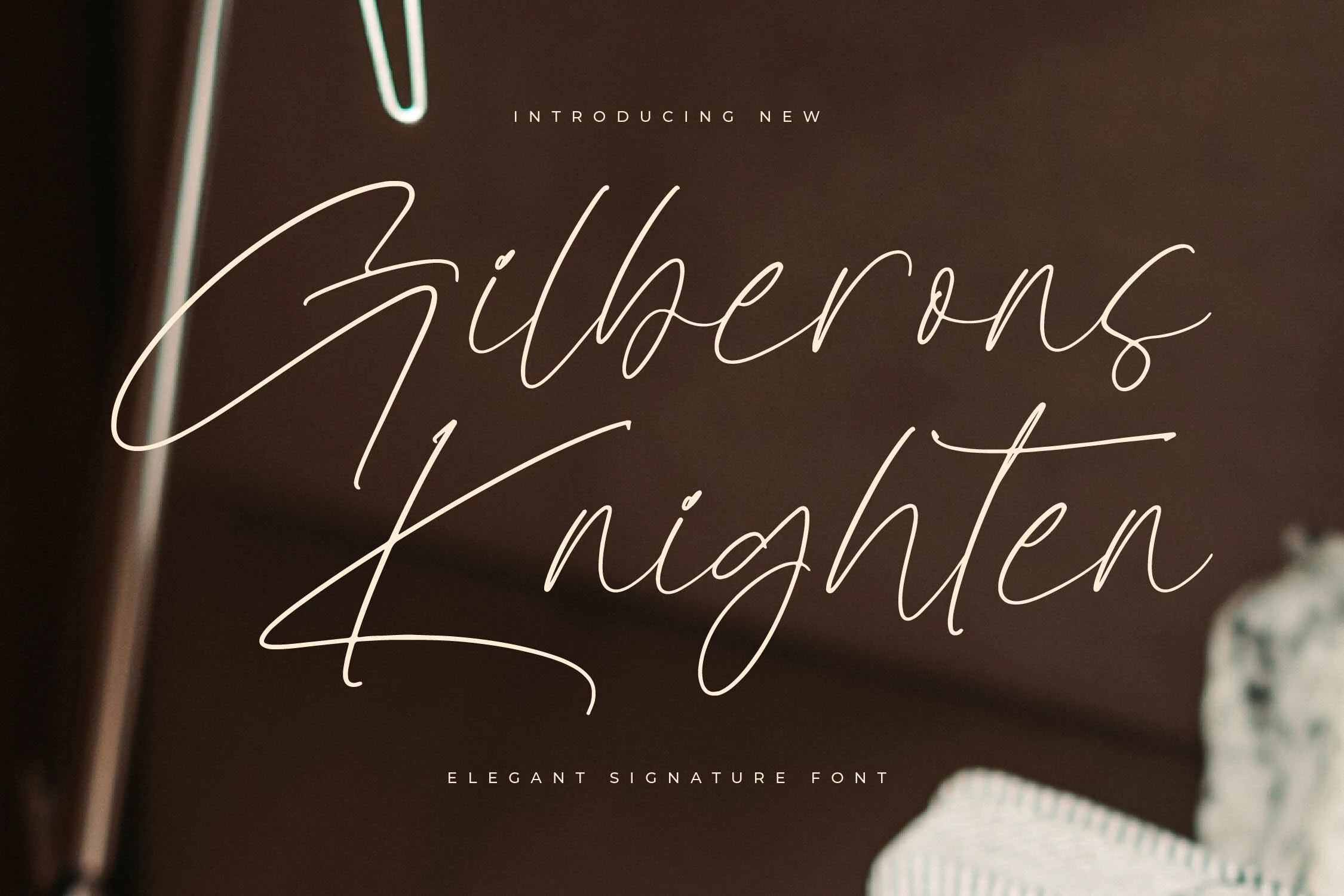 Gilberons Knighten Font preview in thin cream signature script with tall looping capitals
