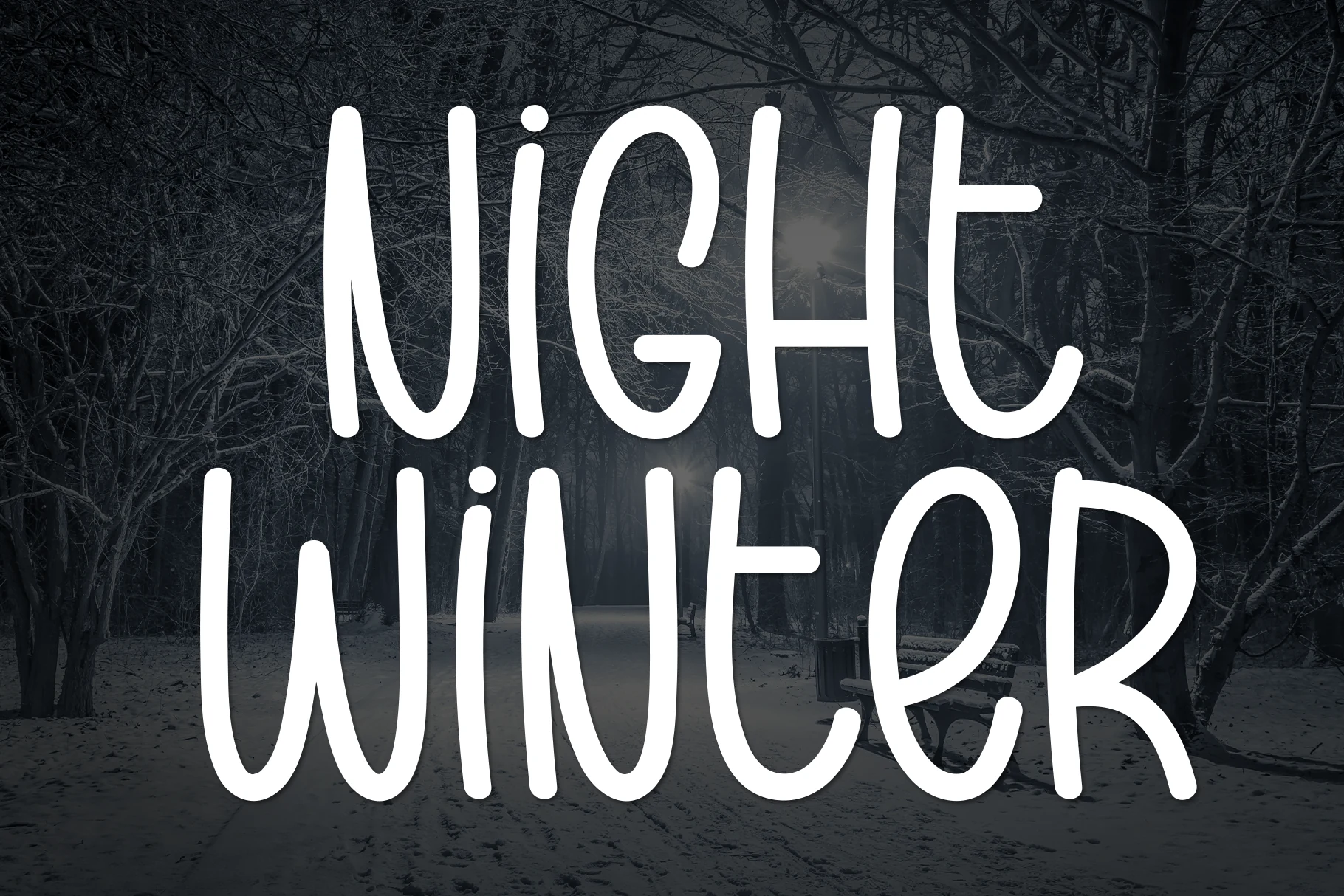 Night Winter Font preview in tall white casual handwritten lettering with narrow rounded strokes