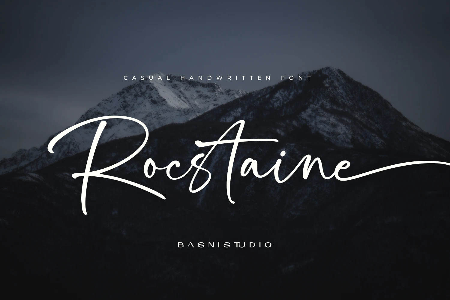 Rocstaine Handwritten Font preview in elegant white signature-style script with long sweeping strokes