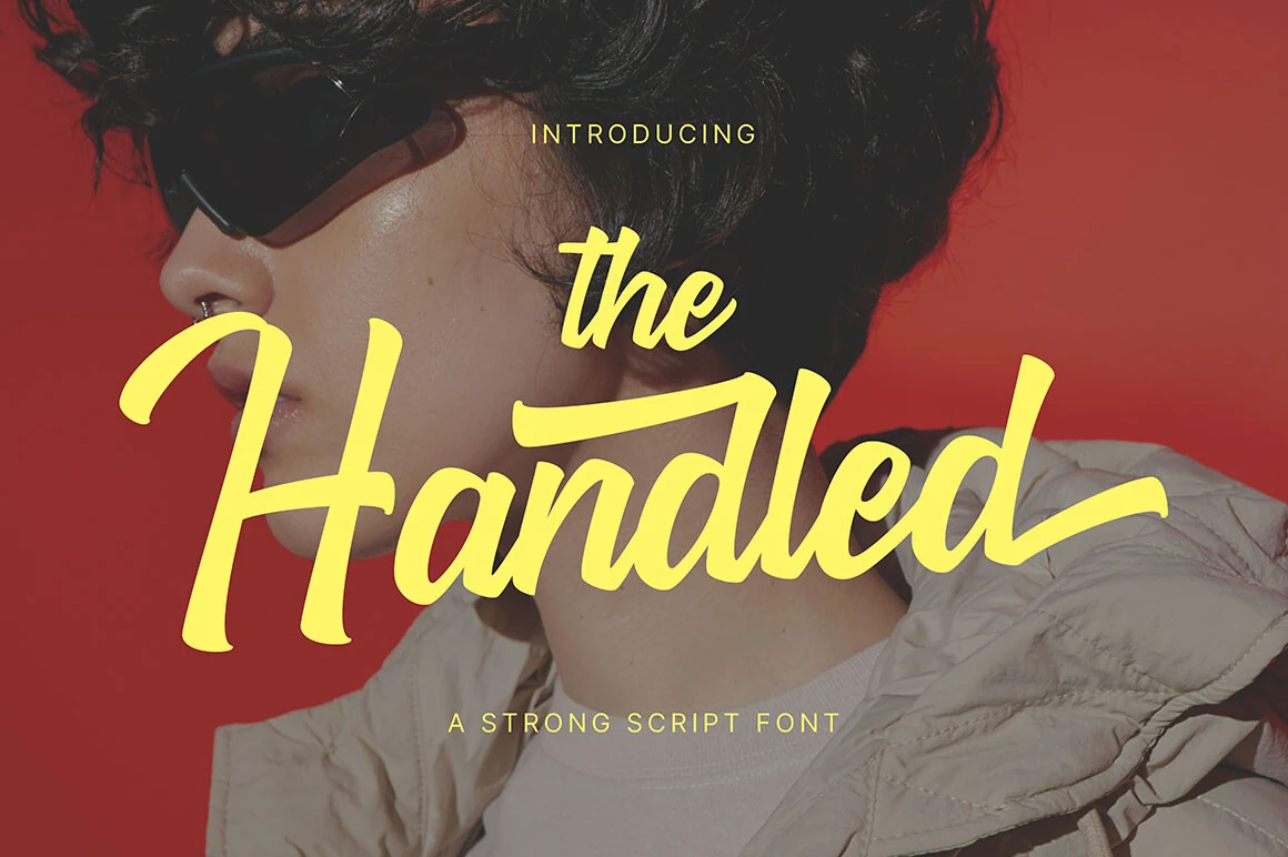 The Handled Font preview with bold yellow brush-script lettering, connected strokes, and long sweeping terminals