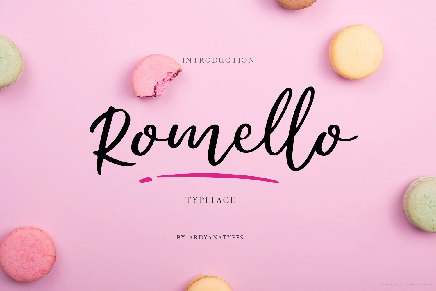 Romello Font shown in large flowing cursive lettering with connected characters, a forward slant, and rounded handwritten strokes.