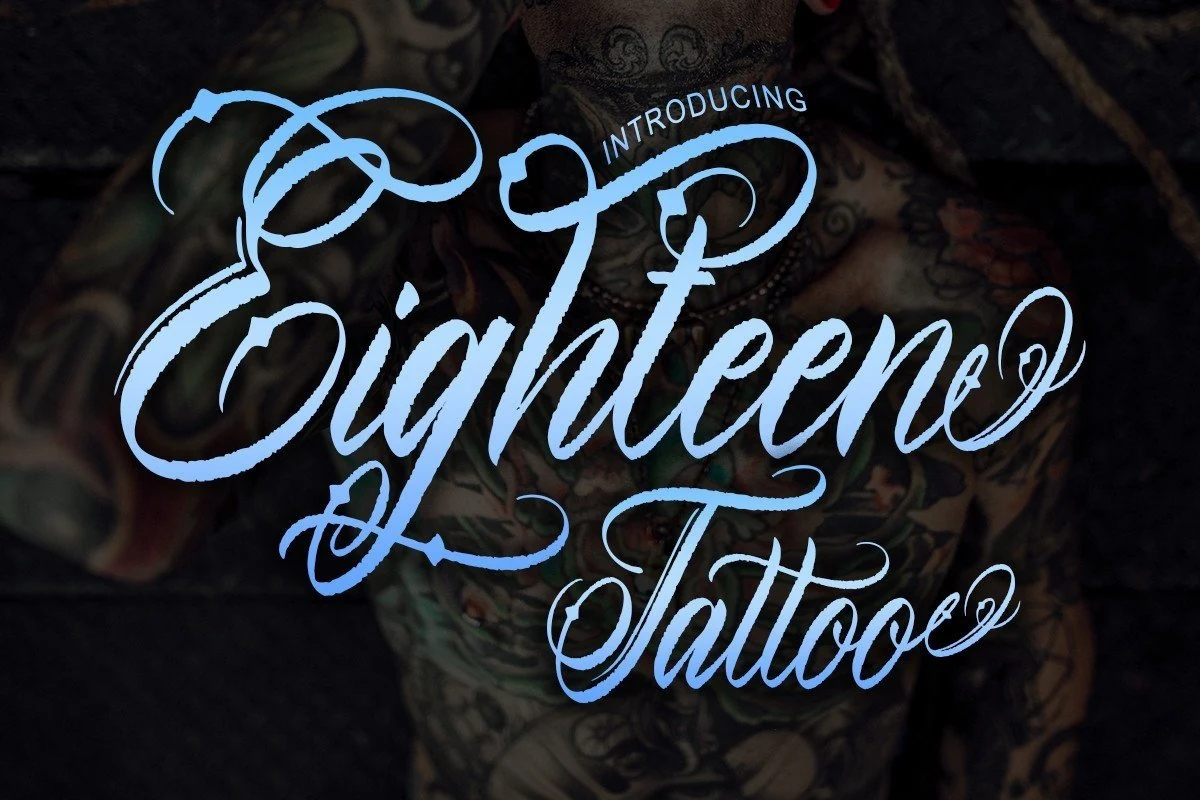 Eighteen Tattoo Font features a decorative connected calligraphic script with high contrast, slanted letterforms, and elaborate swashes.
