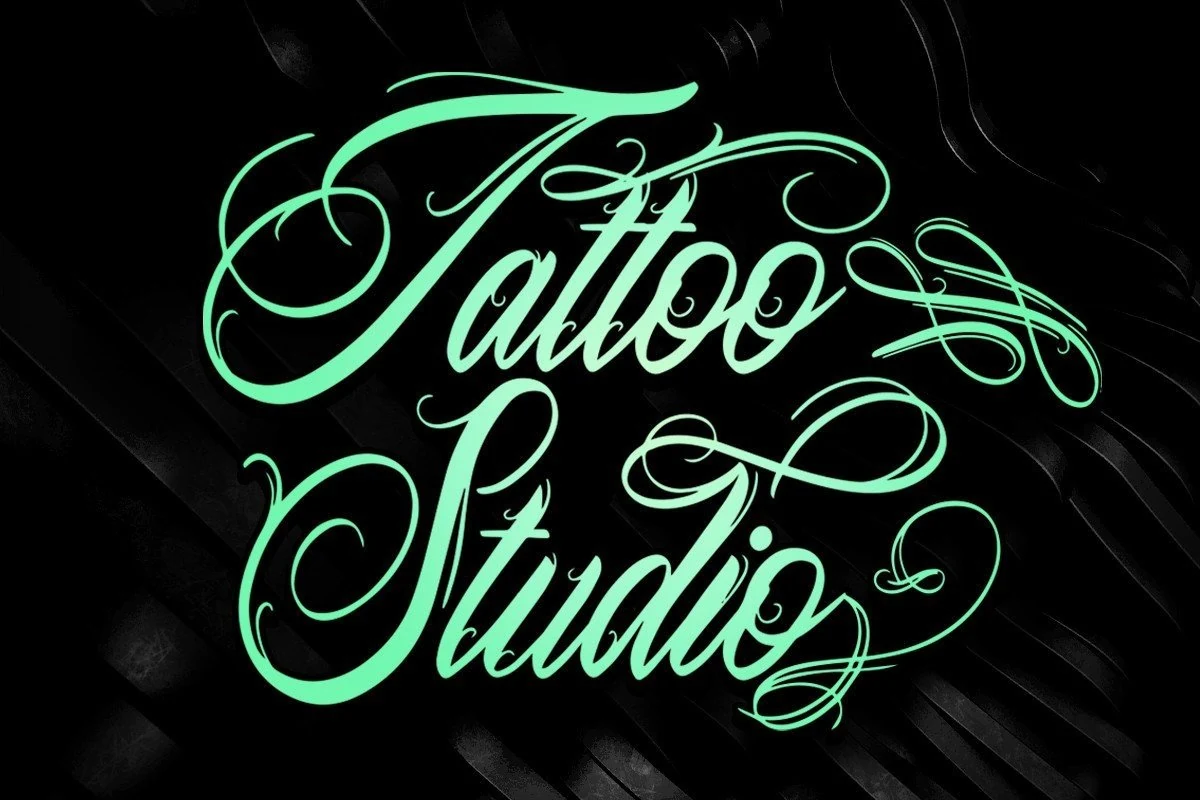 Tattoo Studio Font rendered in connected calligraphic script with high stroke contrast and elaborate ornamental swashes.